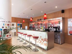 a bar in a restaurant with stools at Hotel ibis Porto Sao Joao in Porto