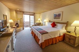 a hotel room with a bed and a television at Inn on the Alameda in Santa Fe