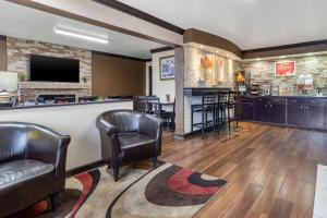 a bar in a hotel room with leather chairs at Econo Lodge in Rock Hill