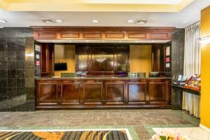 a large kitchen with wooden cabinets in a restaurant at Quality Inn Central in Richmond