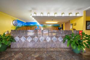 a lobby with a bar with potted plants at Econo Lodge in Decatur