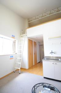 a room with a ladder and a sink and a kitchen at BK Hotel & Weekly in Wakayama