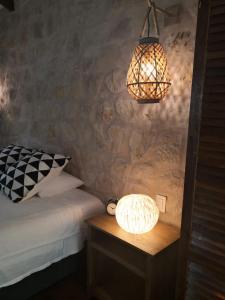 a bedroom with a bed and a lamp on a table at Boutique Hotel y Spa Tangara Azul in Ojochal