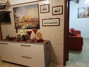 a kitchen with a dresser with a painting on the wall at Ca' Marcella in Venice
