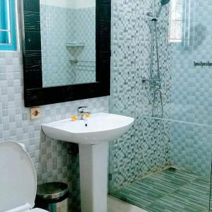 a bathroom with a sink and a shower at Cantik Villa Tugu Belanda in Lovina