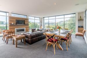 a living room with a table and a couch at La Maison De Verre - Akaroa Holiday Home in Akaroa