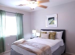 a bedroom with a large bed with a ceiling fan at Phoenix I, Minutes to Airport and Downtown in Phoenix