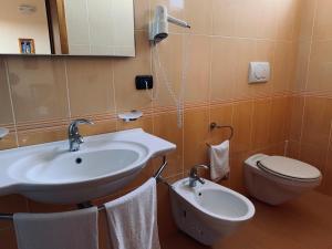 a bathroom with a sink and a toilet at Hotel Costa Blu in Sant'Isidoro +61 photos
