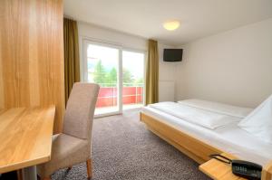 Postel nebo postele na pokoji v ubytování Hotel LukasMayr