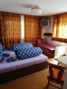 a bedroom with two beds and a table and a tv at Appartement Raggl in Jerzens