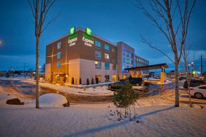 a building with a sign on it in the snow at Holiday Inn Express & Suites - Hermiston Downtown, an IHG Hotel in Hermiston