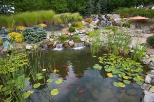a pond with a waterfall in a garden at Holiday Inn Express & Suites - Sharon-Hermitage, an IHG Hotel in West Middlesex