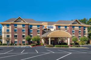 a hotel with a parking lot in front of it at Comfort Inn and Suites in Suwanee