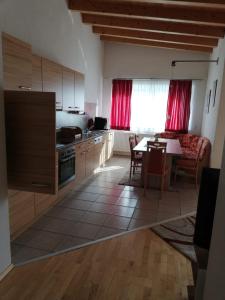a kitchen with a table and a dining room at Appartement Raggl in Jerzens