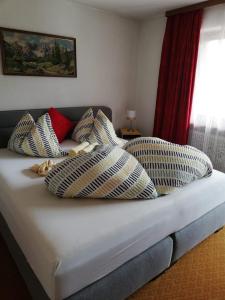 a bed with checkered pillows on top of it at Appartement Raggl in Jerzens