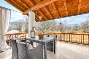 a patio with a table and chairs on a deck at The Alpine Apartment in Garmisch-Partenkirchen