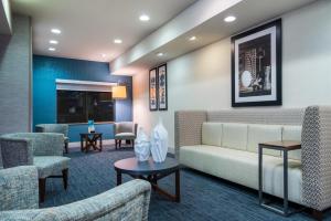 a waiting room with a couch and chairs at Holiday Inn Express & Suites Rocky Mount Smith Mountain Lake by IHG in Rocky Mount