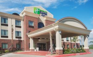 a hotel with a sign on the front of it at Holiday Inn Express Hotel & Suites Winnie, an IHG Hotel in Winnie