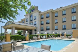 an image of a hotel with a pool and tables and chairs at Holiday Inn Express Hotel & Suites San Antonio NW-Medical Area by IHG in San Antonio