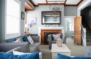 a living room with couches and a fireplace at Puriri Downtown Villa - Napier Holiday Home in Napier