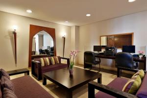 
a living room filled with furniture and a tv at Holiday Inn Resort Dead Sea, an IHG Hotel in Sowayma
