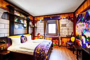 a bedroom with a bed and a table and a window at LEGOLAND Castle Hotel in Billund