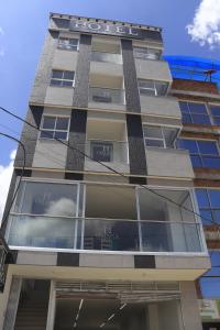 a tall building with a sign on it at Hotel Omaga El peñol- Guatape in El Peñol