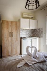 a kitchen with a towel in the shape of a heart at Studios Finikes in Limenas