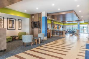 a lobby of a hospital with tables and chairs at Holiday Inn Express & Suites Clarion, an IHG Hotel in Clarion