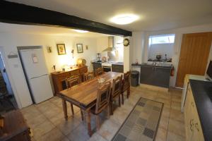 a large kitchen with a wooden table and chairs at Pier Cottage in Watchet