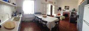 a kitchen and living room with a table with chairs at Beach House in Zagora +9 photos