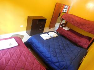 a bedroom with two beds and a dresser in it at Hospedaje Sol de Reyes Jujuy in Reyes