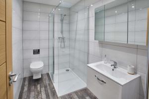 a bathroom with a shower and a toilet and a sink at Host & Stay - Apartment One, Hudsons Yard House in Whitby