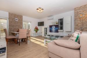 a living room with a couch and a table at APARTMAN ŠARE in Crikvenica