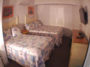 a hotel room with two beds and a television at Ocean Walk Resort - Remarkable Ocean Front View in Daytona Beach +36 photos