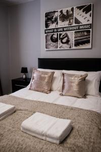 two beds with pillows sitting next to each other at Inspired Stays in Stoke on Trent