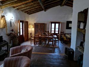 a living room with a table and chairs at Casa Do Alto Da Eira in Albergaria dos Fusos