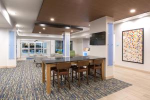 a dining room with a table and some chairs at Holiday Inn Express & Suites Lincoln I - 80, an IHG Hotel in Lincoln