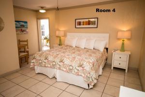 a bedroom with a bed and a dresser at Haley's at Anna Maria Island Inn in Holmes Beach