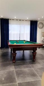 a pool table with balls on it in a room at La maison écolo de Nono in Dhuizon +10 photos