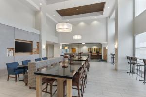 a kitchen with a table and chairs in it at Holiday Inn Express Hotel & Suites Sacramento Airport Natomas, an IHG Hotel in Sacramento