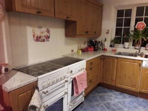 a kitchen with a white stove and a sink at Home from home, single room with virgin channels, Wifi & free parking in Poole