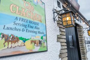 a sign on the side of a free house serving true aids lunches and exciting at The Clachan Inn in Drymen