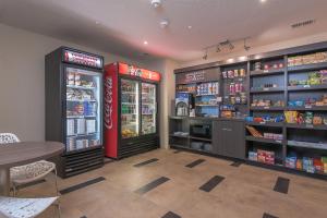 a grocery store with two soda machines and a table at Candlewood Suites Bloomington, an IHG Hotel in Bloomington