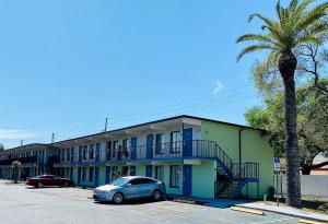 a blue car parked in front of a building at Gulf Way Inn Clearwater in Clearwater