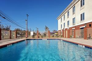 a swimming pool in front of a building at Holiday Inn Express & Suites Ozona, an IHG Hotel in Ozona