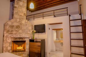 a living room with a fireplace and a bunk bed at Casa Mateo Hotel Boutique in Bernal +82 photos