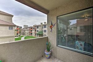 a window with a bird on the side of a building at Modern Condo with Pool about 3 Mi to Downtown Phoenix! in Phoenix