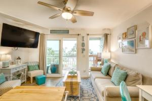 a living room with a couch and a tv at Sea Cabin 232-C in Isle of Palms