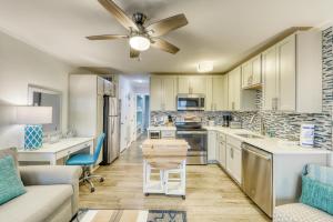 a kitchen and living room with a couch and a ceiling fan at Sea Cabin 232-C in Isle of Palms
